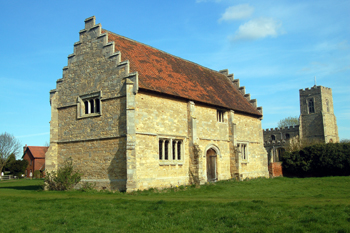 The stables three-quarter view with the church in the background April 2010